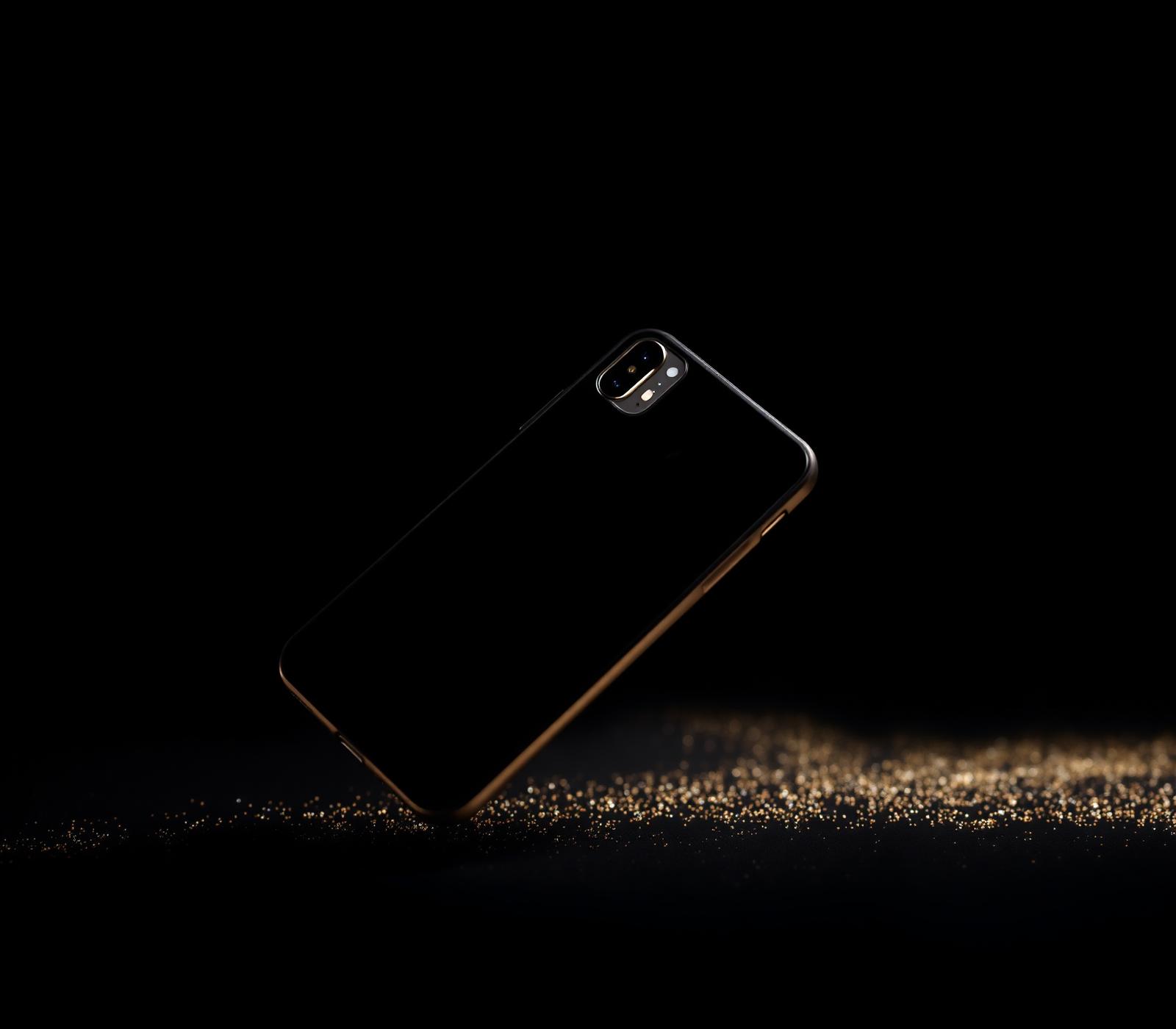 iPhone premium sobre fondo negro con destellos dorados